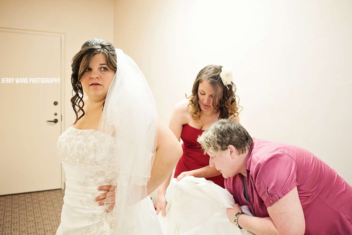 Putting the final touches on the bride's dress
