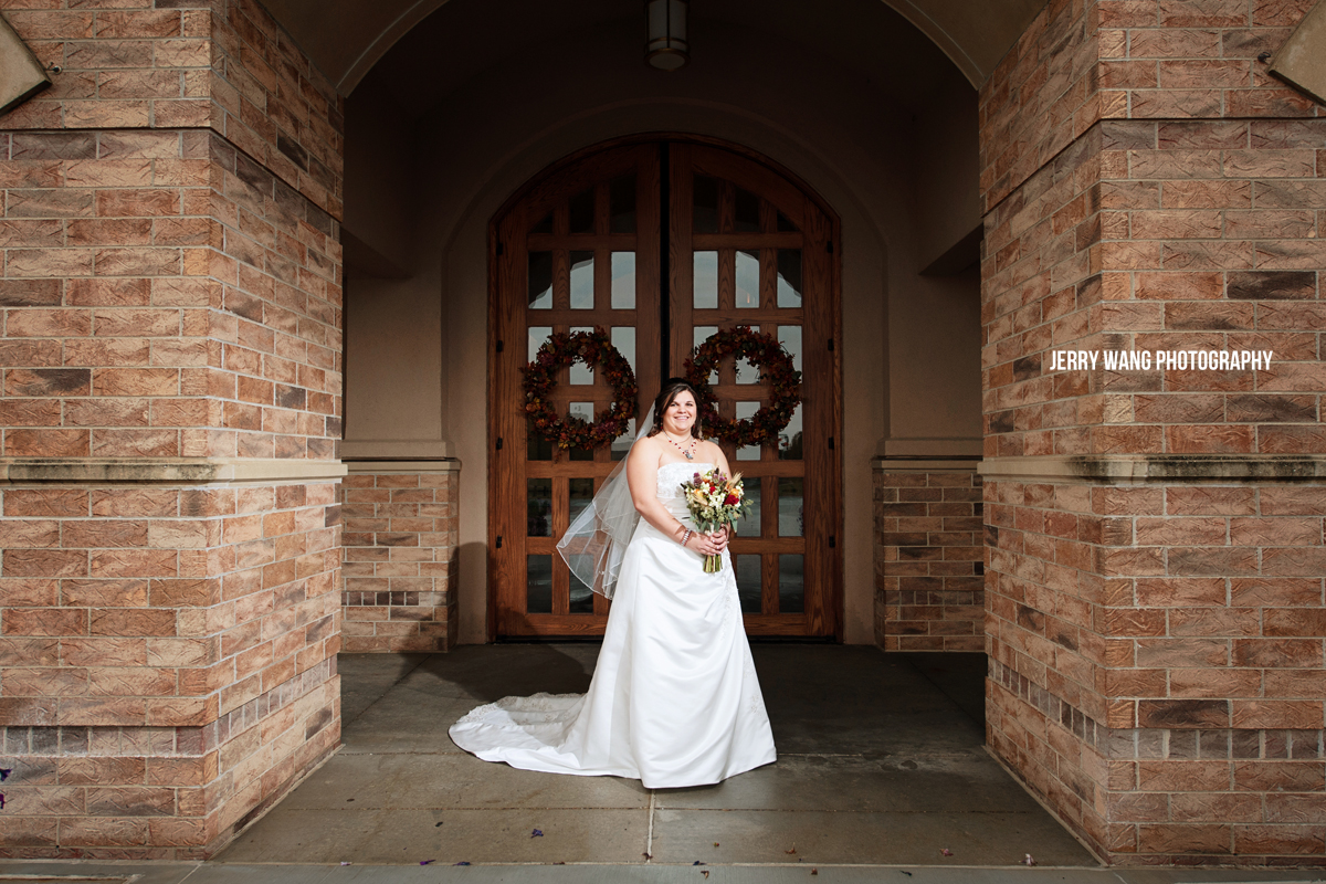 The bride standing in front of Corpus Christi Catholic Church