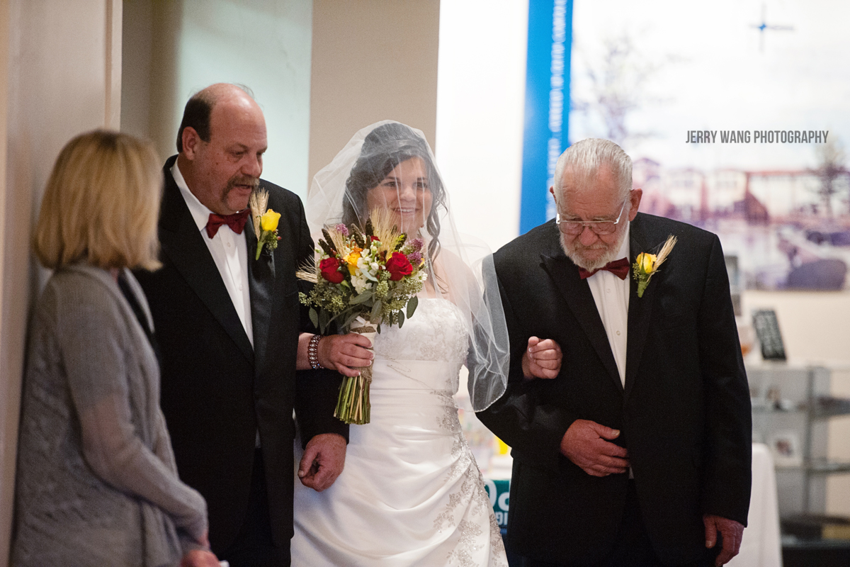 The bride escorted by her father down the aisle