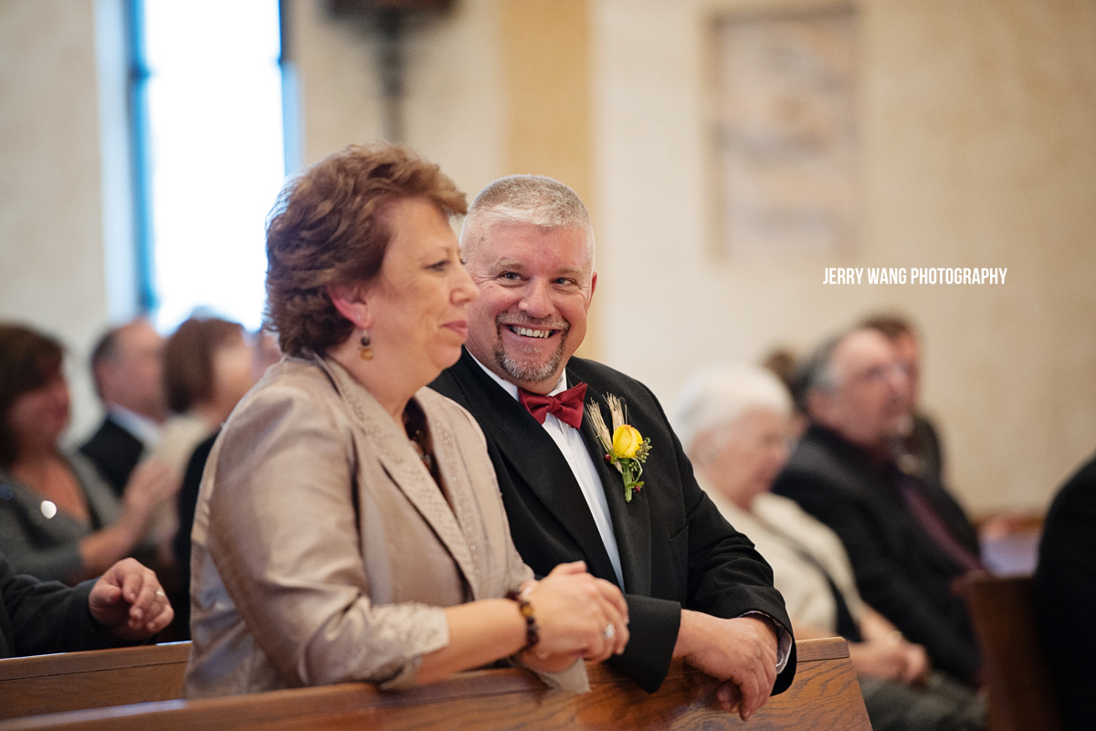 The father of the groom smiling